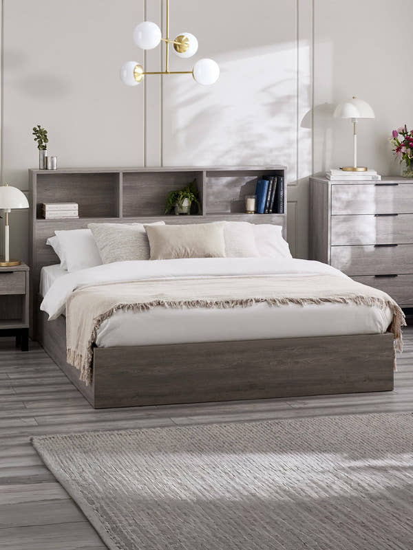 Julian Bowen Bali ottoman bed in grey oak effect with a bookcase headboard, in a bedroom