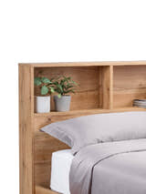 Bali ottoman bed: light oak effect bookcase headboard with plants on the shelves, close up