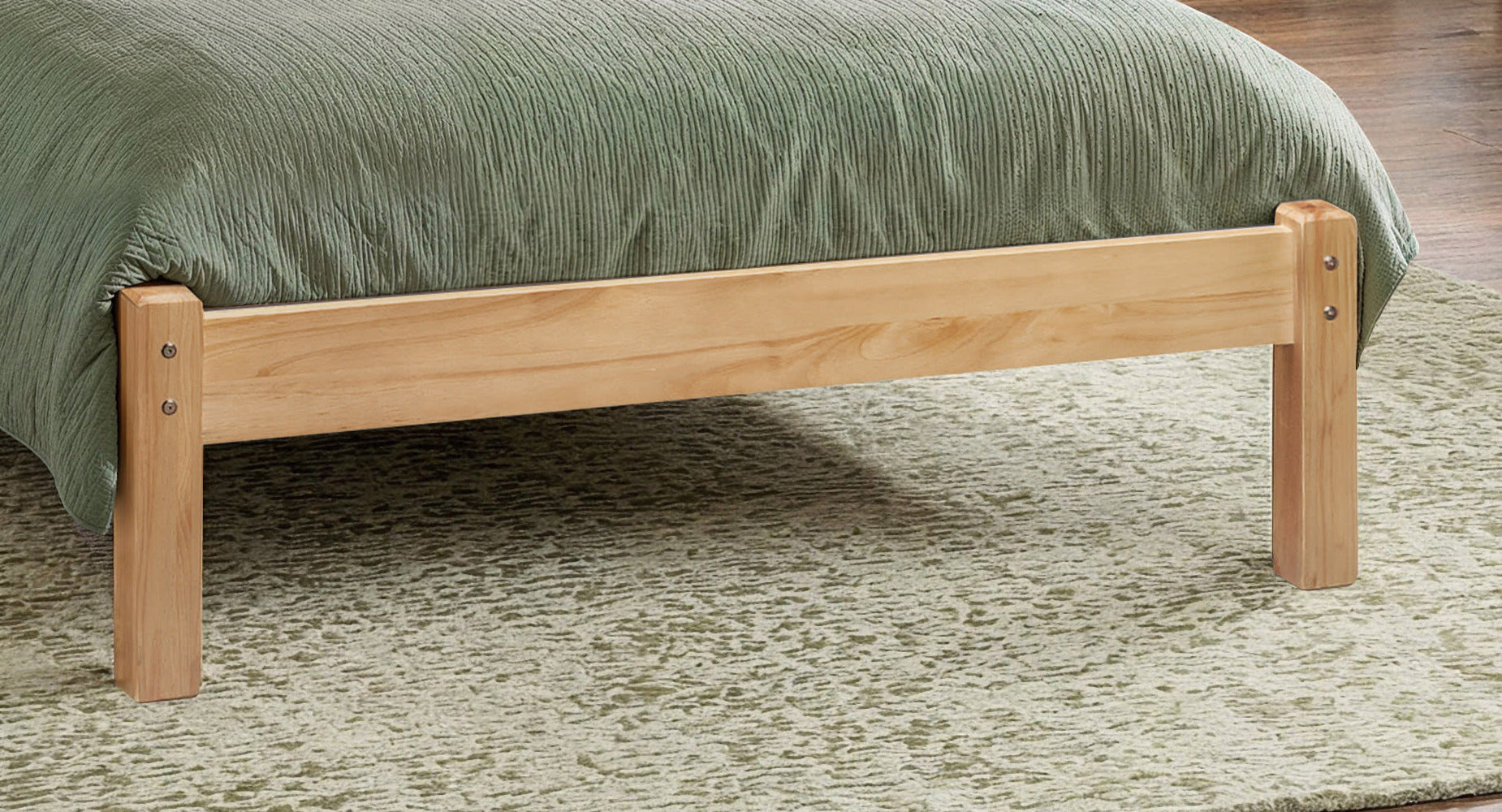 Julian Bowen Barcelona antique pine low footend and legs on a rug, close up