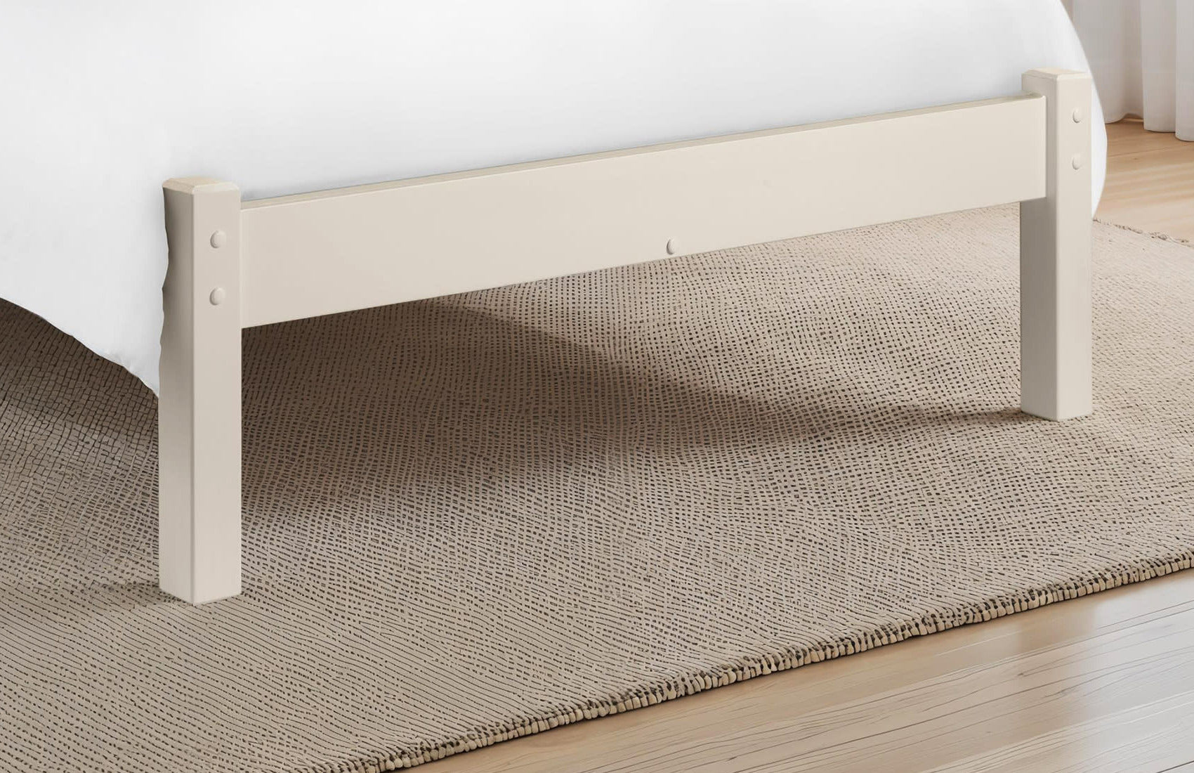 Julian Bowen Barcelona stone white low footend and legs on a rug, close up