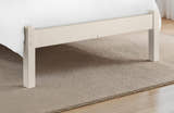 Julian Bowen Barcelona stone white low footend and legs on a rug, close up