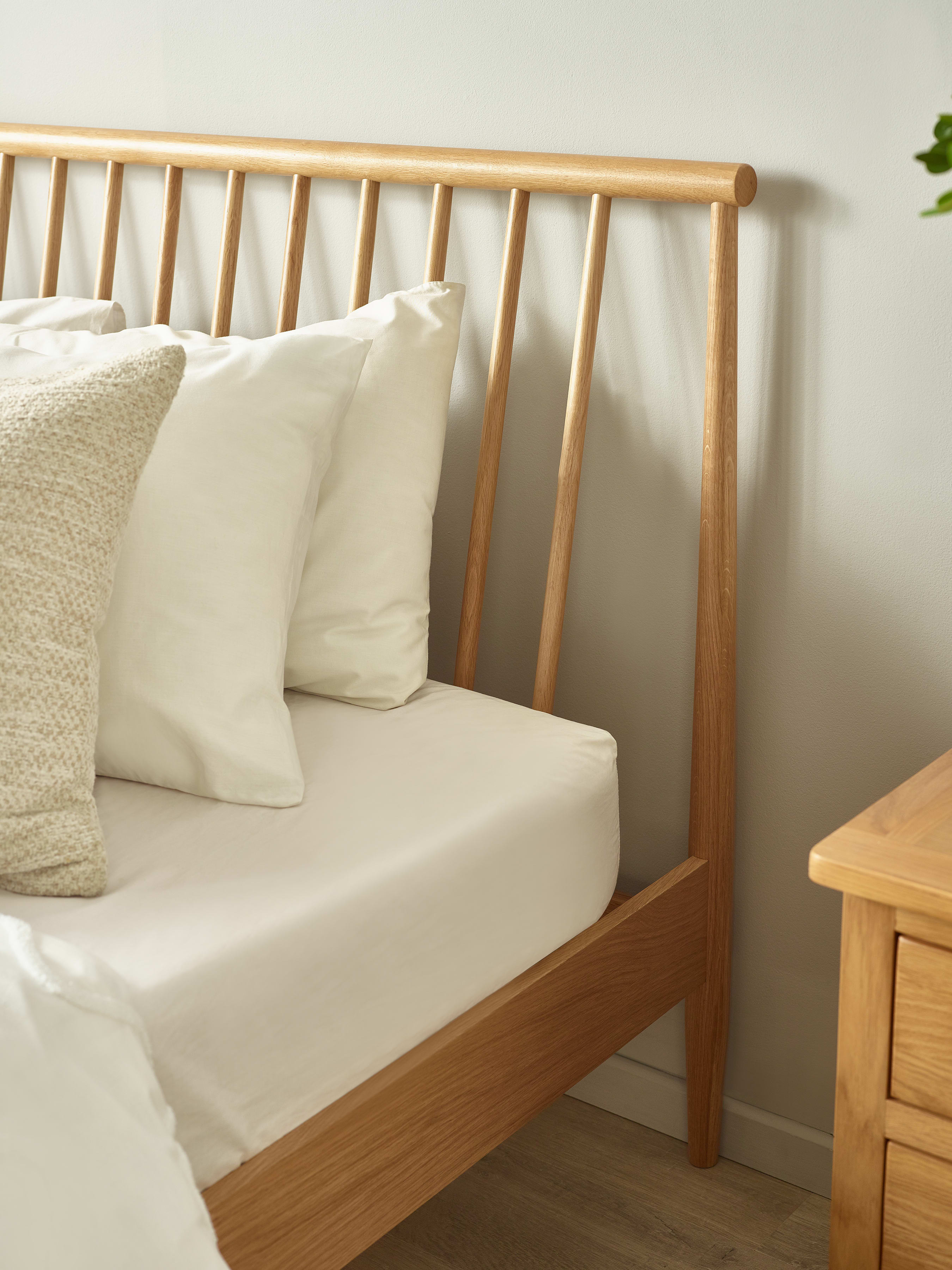 Belton bed: the slanted oak spindles of the headboard, close up