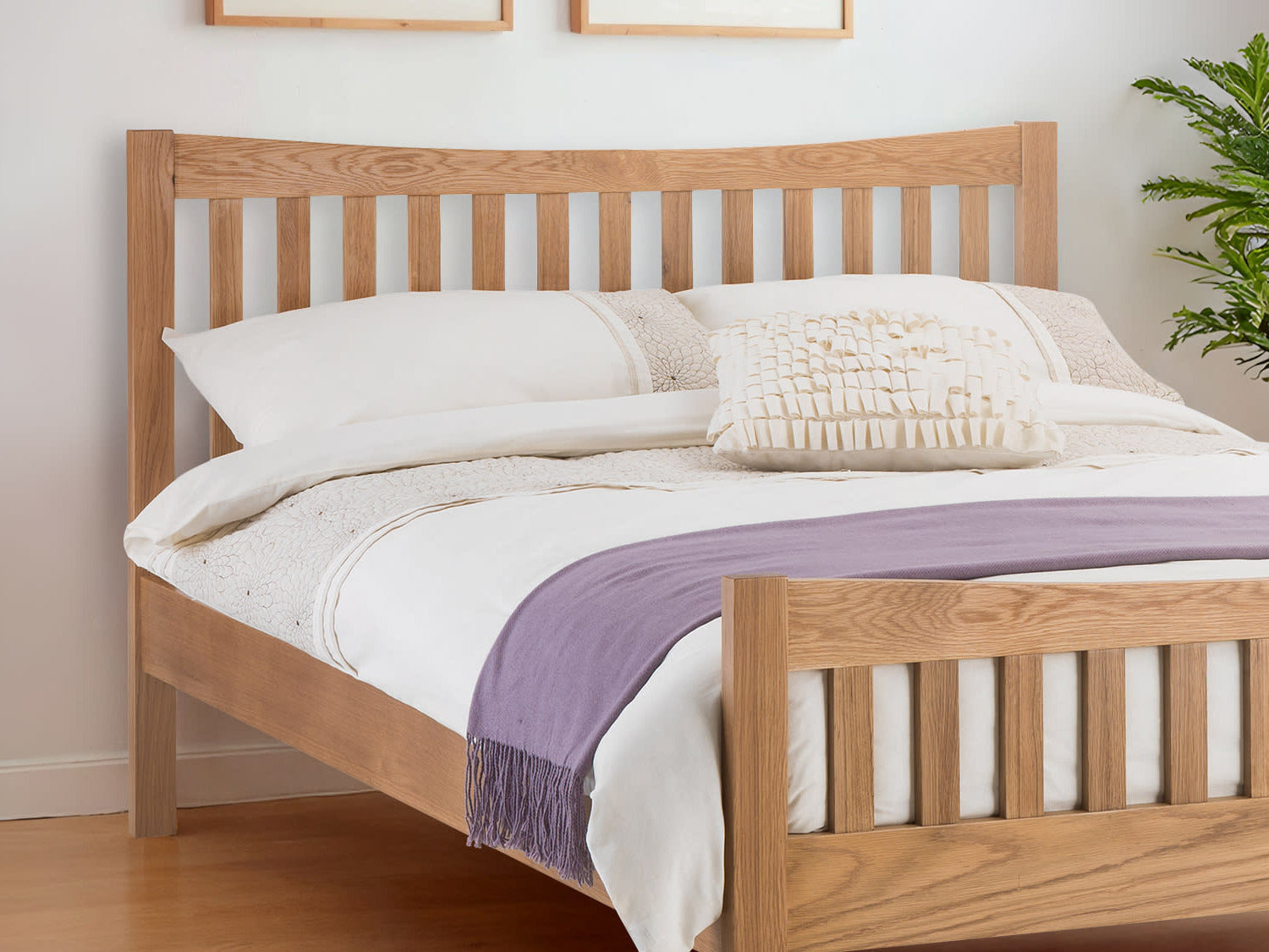 Julian Bowen Bergamo oak bed: curved slatted headboard in a bright bedroom, close up