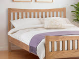 Julian Bowen Bergamo oak bed: curved slatted headboard in a bright bedroom, close up