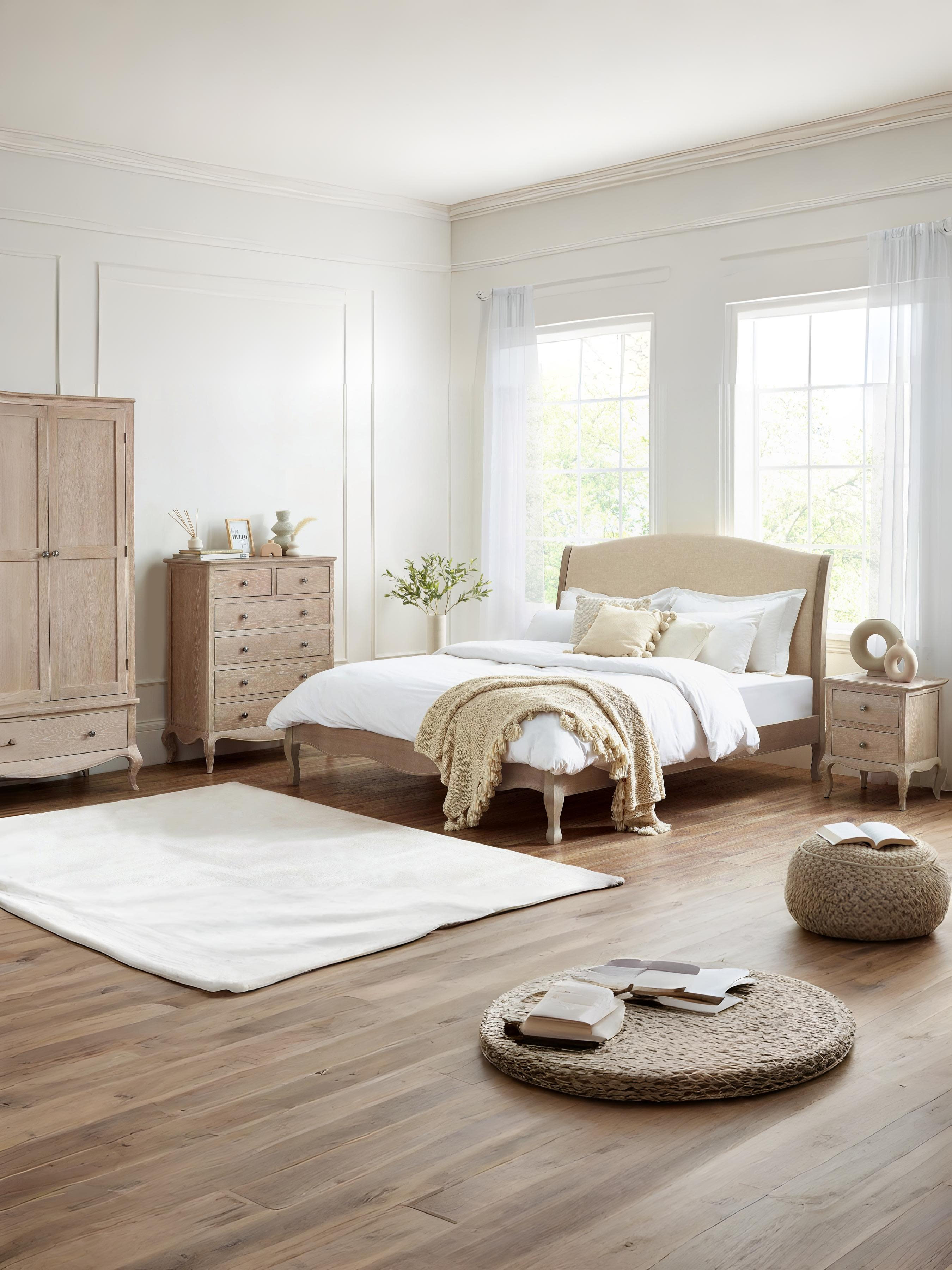 Camille limed oak bed with matching bedroom furniture, in a large room with wooden floor