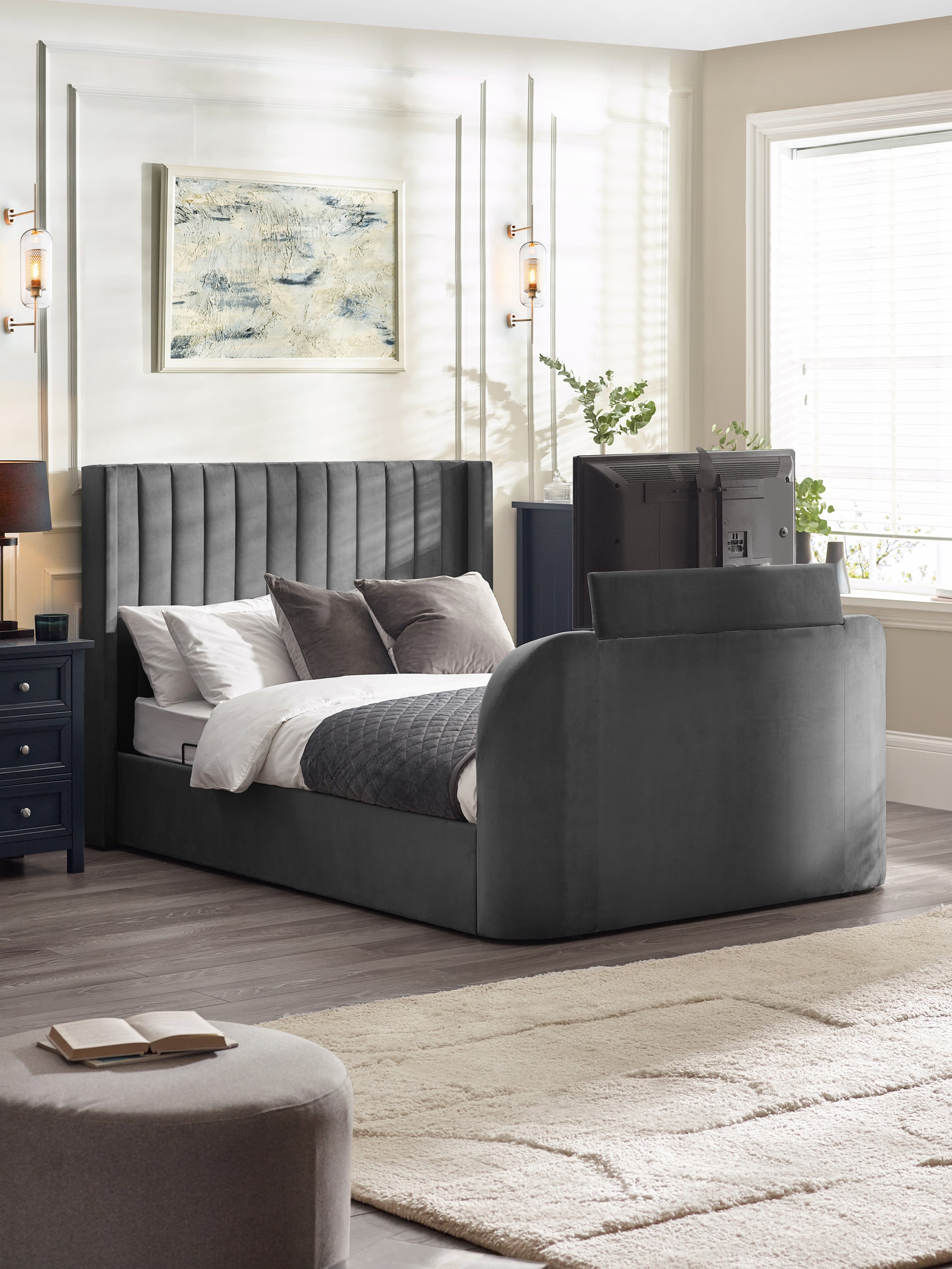 Julian Bowen Clara TV bed in dark grey velvet with the TV raised out of the footboard, in a bedroom