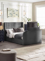 Julian Bowen Clara TV bed in dark grey velvet with the TV raised out of the footboard, in a bedroom
