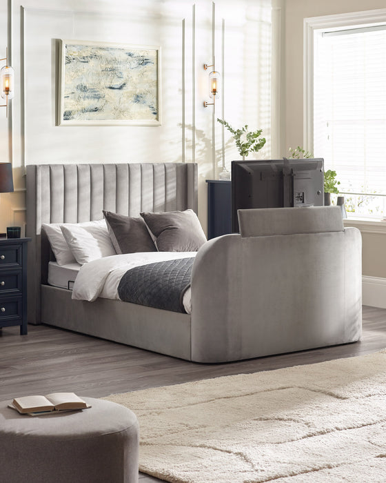Julian Bowen Clara TV bed in light grey velvet with the TV raised out of the footboard, in a bedroom