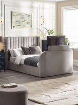 Julian Bowen Clara TV bed in light grey velvet with the TV raised out of the footboard, in a bedroom
