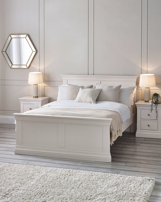 Julian Bowen Clermont bed in surf white, in a bedroom with panelled walls and bedside lamps