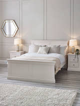Julian Bowen Clermont bed in surf white, in a bedroom with panelled walls and bedside lamps