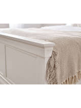 Clermont bed: the surf white panelled footboard with a throw, close up