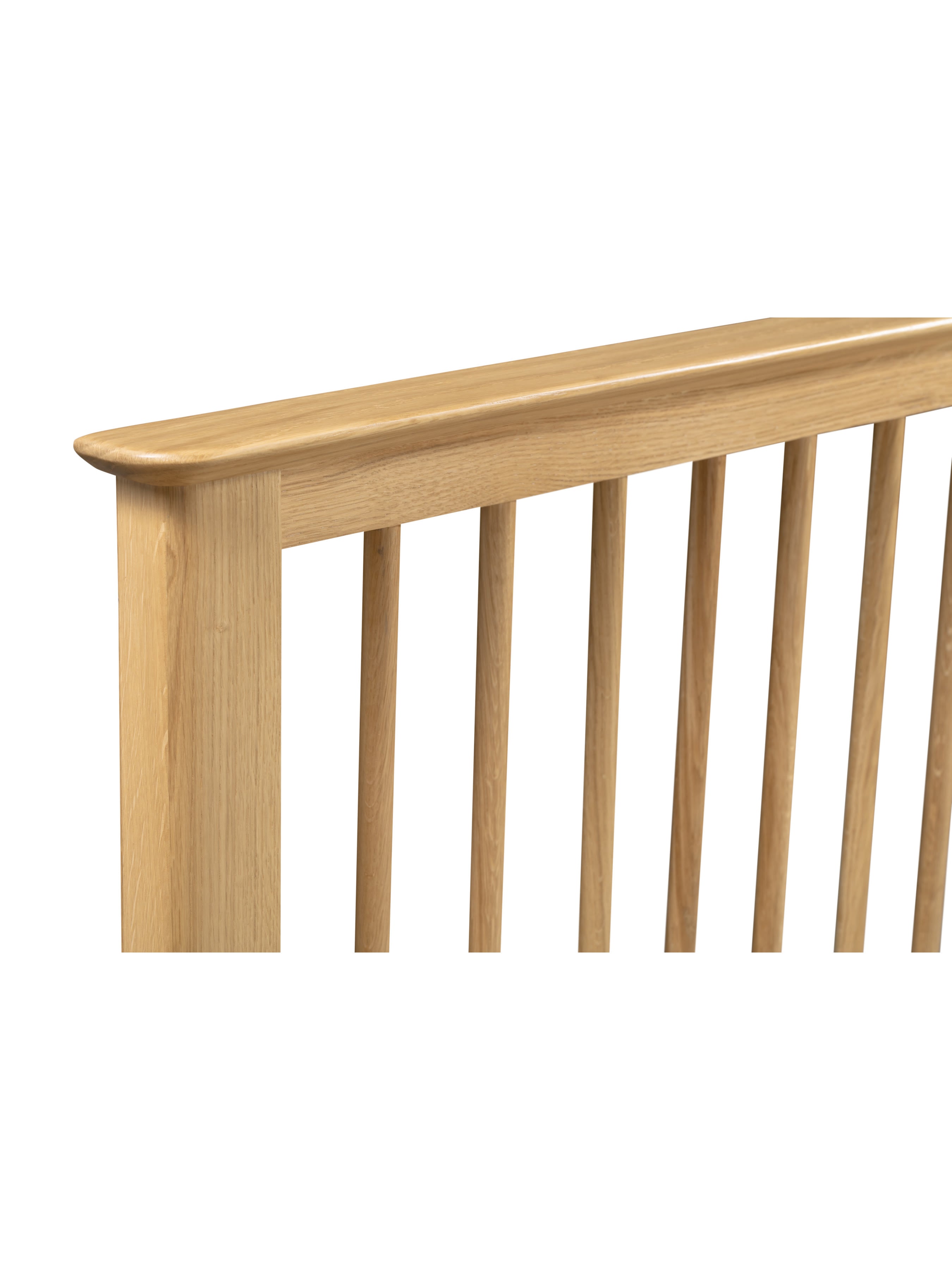 Cotswold bed: oak top rail and spindles of the headboard, close up