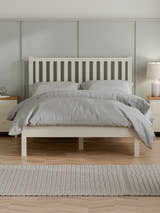 Julian Bowen Coxmoor bed in ivory with a tall slatted headboard, in a bedroom