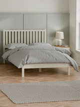Julian Bowen Coxmoor ivory bed with grey bedding in a panelled bedroom