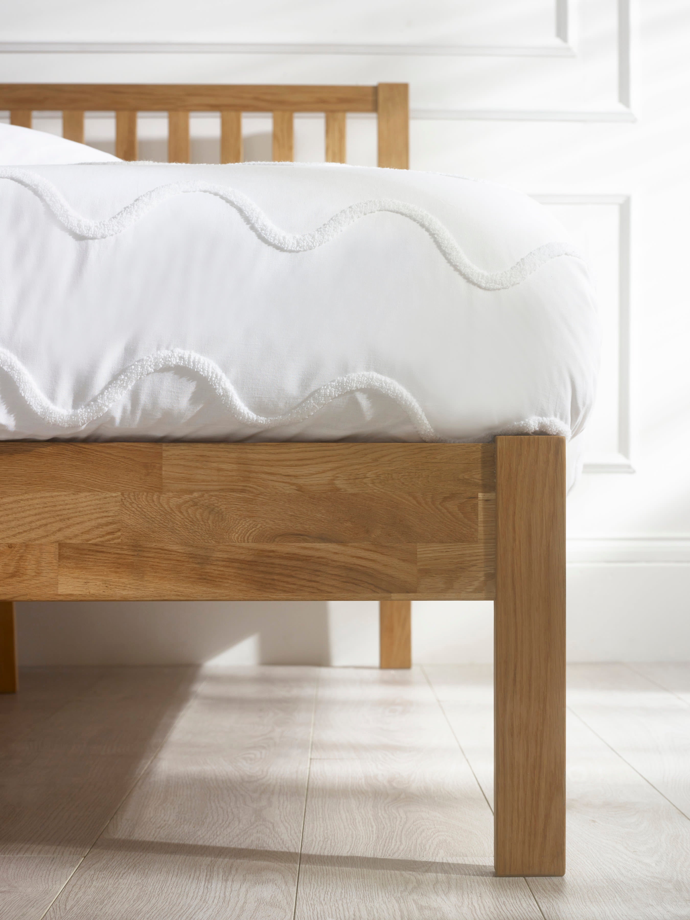 Coxmoor bed: oak side rail and straight leg under the mattress, close up