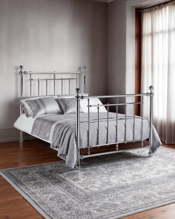 Julian Bowen Empress chrome bed with a high headboard and footboard, in a bedroom with a grey rug