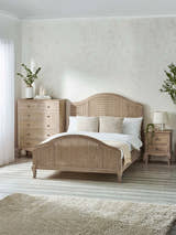 Julian Bowen Fleur rattan bed in limed oak, in a bedroom