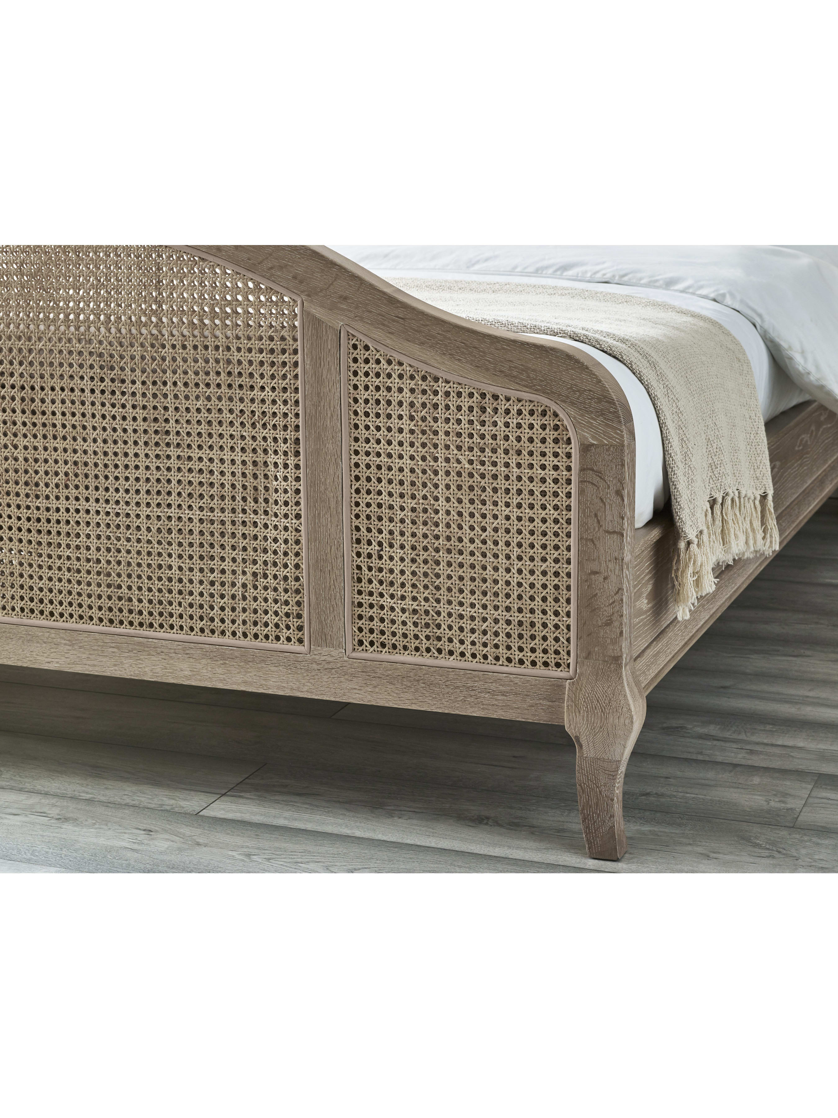 Fleur bed: the arched cane footboard and curved leg, in a bedroom