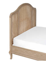 Fleur bed: the arched woven cane headboard, close up