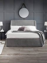 Julian Bowen Frida grey velvet ottoman bed with a curved headboard, in a bedroom
