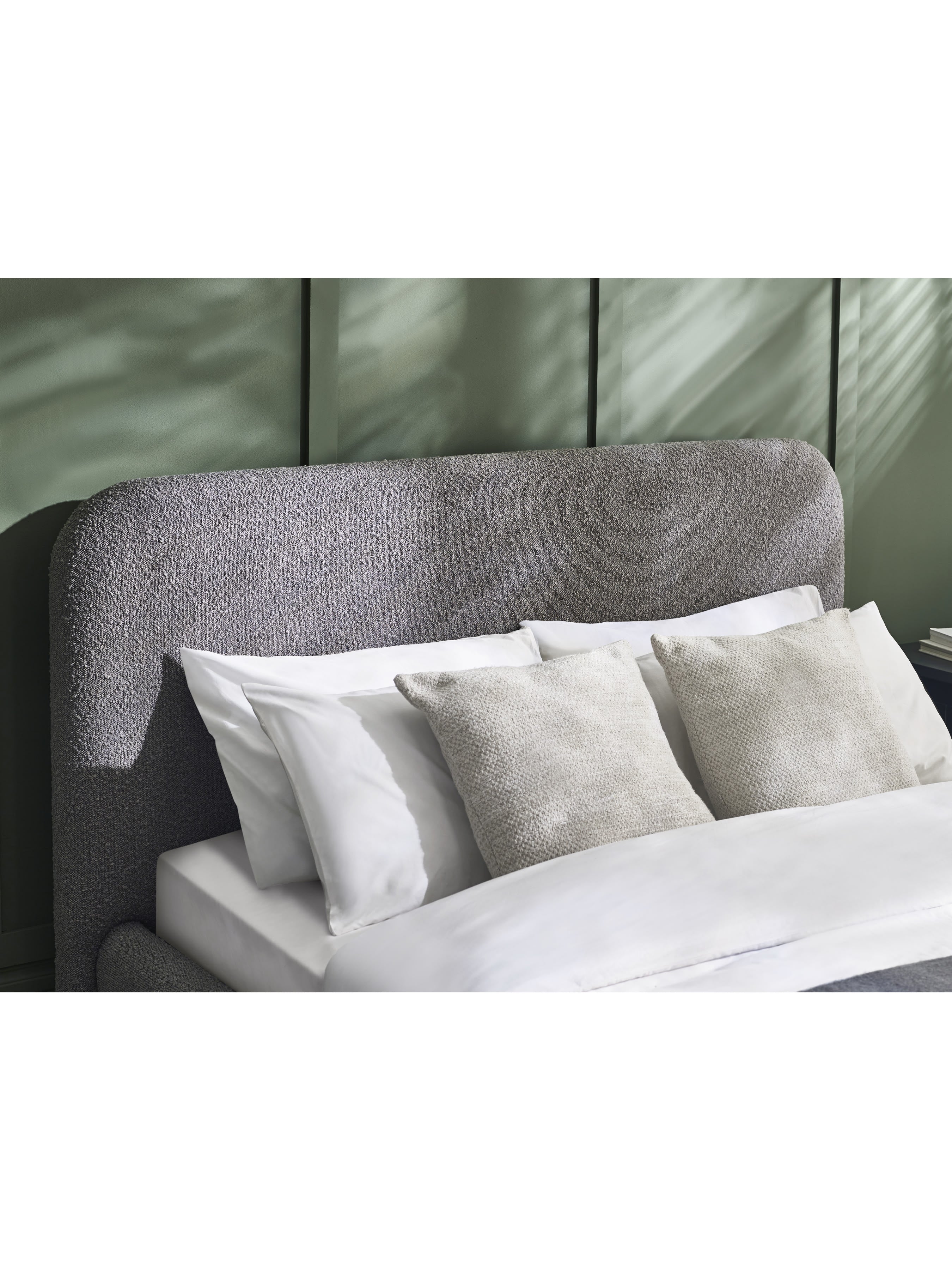 Julian Bowen Hannah grey boucle headboard with cushions, in a bedroom