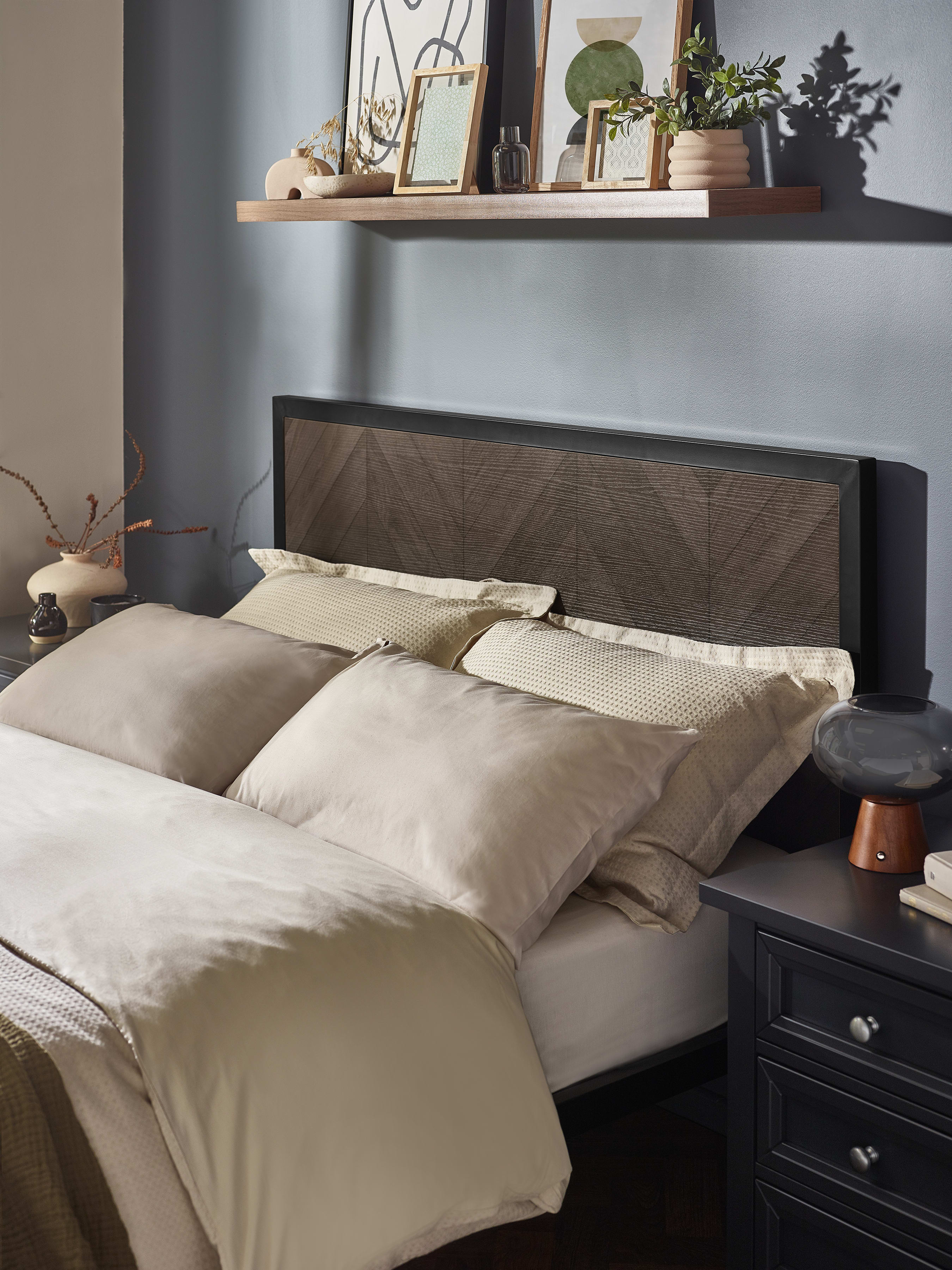 Harrison bed: dark oak herringbone effect headboard in a black frame, behind the pillows