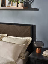 Harrison bed: herringbone headboard panel and black frame, close up