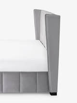 Katie bed: side view of the winged grey velvet headboard, close up