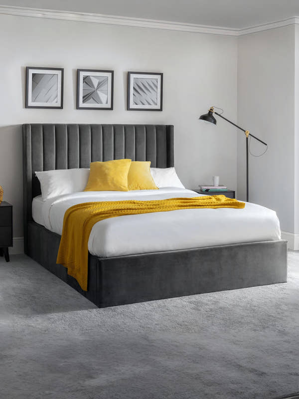 Julian Bowen Langham grey velvet ottoman bed with a tall channelled headboard, in a bedroom