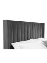 Langham bed: winged grey velvet headboard in vertical channels, close up
