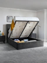 Langham ottoman bed with the base lifted to show the storage, in a bedroom