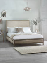 Julian Bowen Lucie bed with oatmeal linen panels in a limed oak frame, in a bedroom