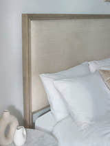 Lucie bed: high oatmeal linen headboard framed in limed oak, behind pillows