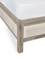 Lucie bed: corner of the limed oak frame and linen panel, close up