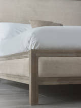 Lucie bed: limed oak foot post and linen side panel, close up