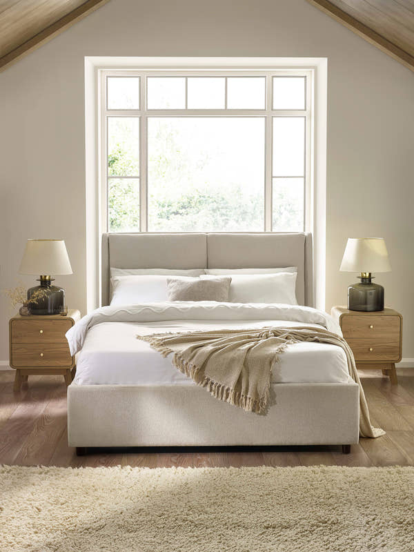 Julian Bowen Maddock beige linen ottoman bed with a two panel headboard, in a bright bedroom