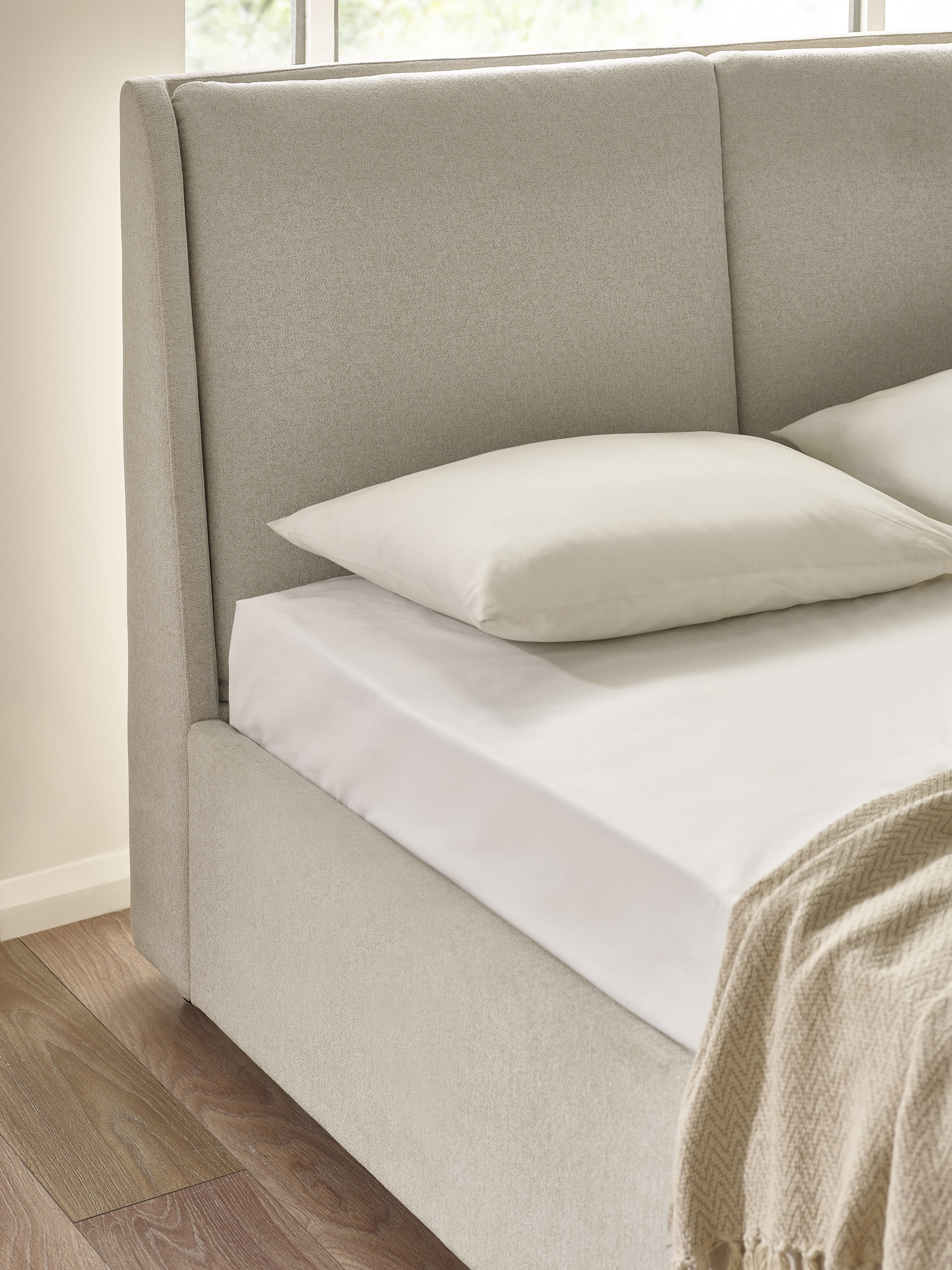 Maddock bed: beige headboard in two padded panels, close up