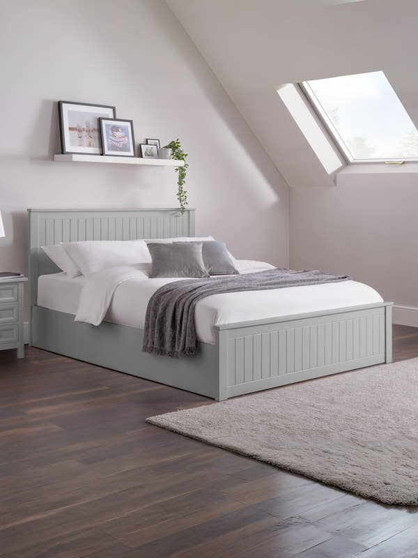 Julian Bowen Maine ottoman bed in dove grey, made up in a loft bedroom