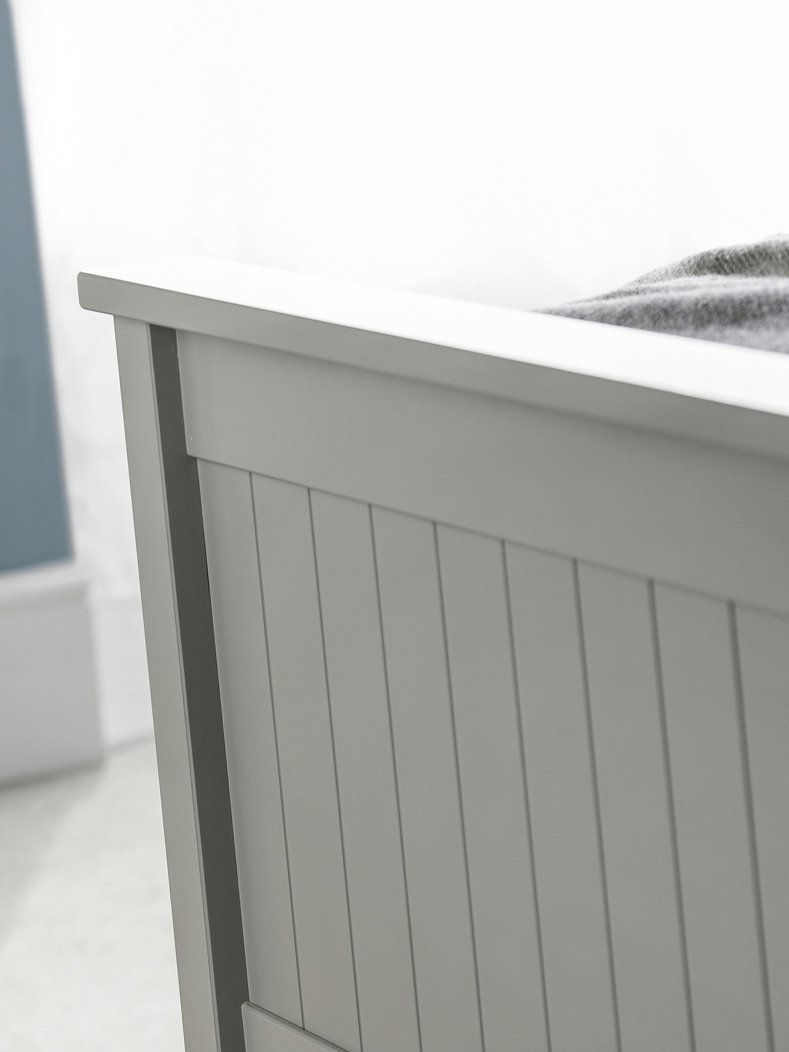 Maine ottoman bed: the dove grey footboard with vertical detailing, close up