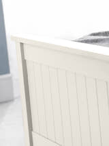 Maine ottoman bed: the surf white footboard with vertical detailing, close up