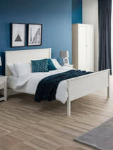 Julian Bowen Maine bed in surf white, in a bedroom with a blue wall