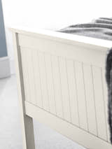 Maine bed: the surf white footboard with vertical detailing, close up