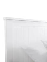 Maine bed: the top of the surf white panelled headboard, close up