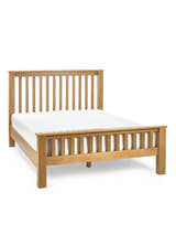 Julian Bowen Mallory high footend oak bed with a mattress, on a white background