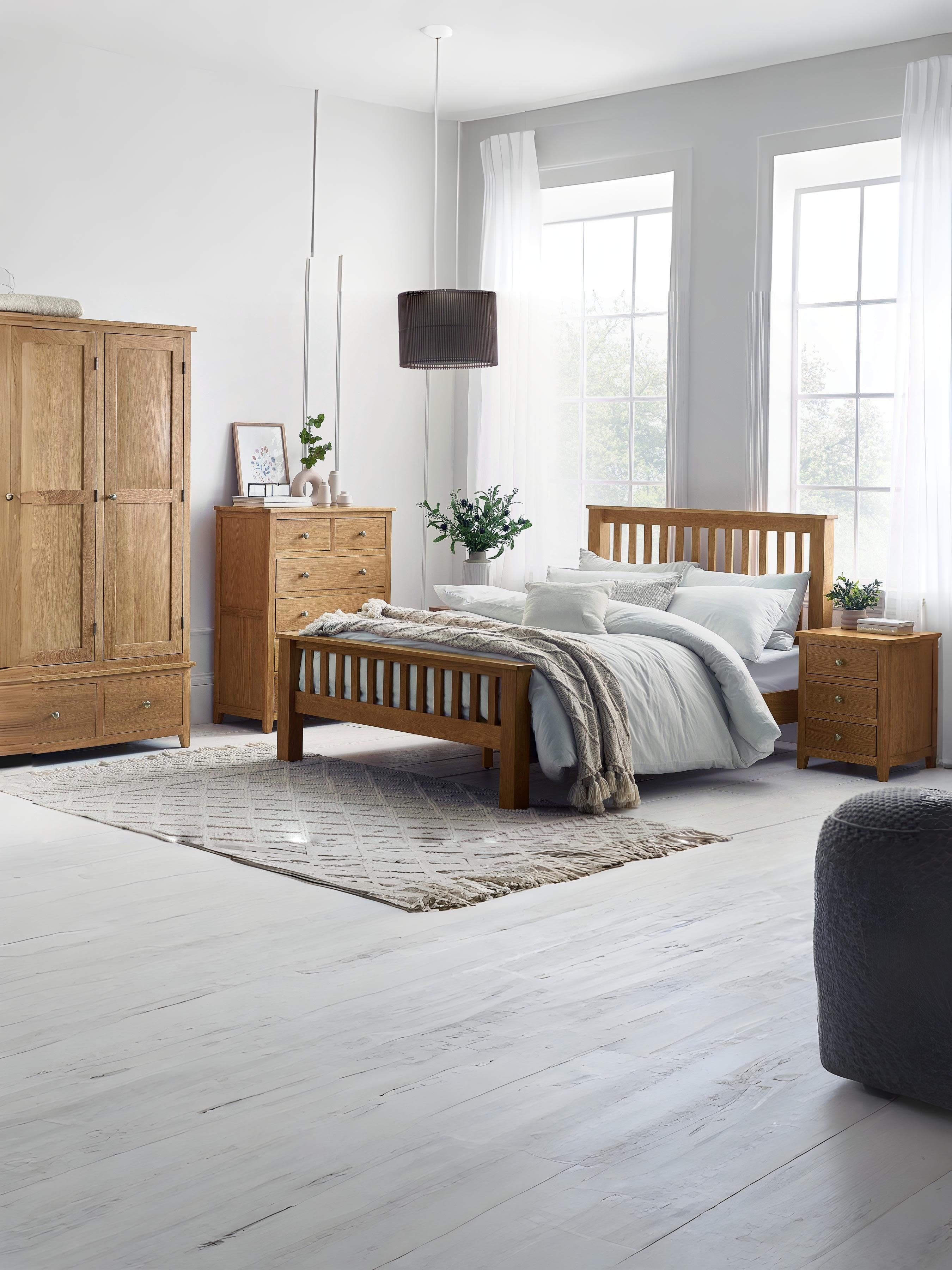 Julian Bowen Mallory oak bed in a large bedroom with an oak wardrobe, wide view