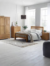 Julian Bowen Mallory oak bed in a large bedroom with an oak wardrobe, wide view