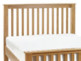 Julian Bowen Mallory oak slatted headboard above a bare mattress, close up