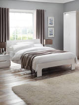 Julian Bowen Manhattan bed in white high gloss, in a bedroom with a rug