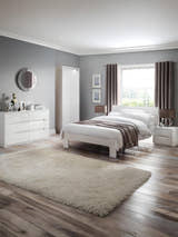Julian Bowen Manhattan white high gloss bed in a bedroom with matching furniture, wide view